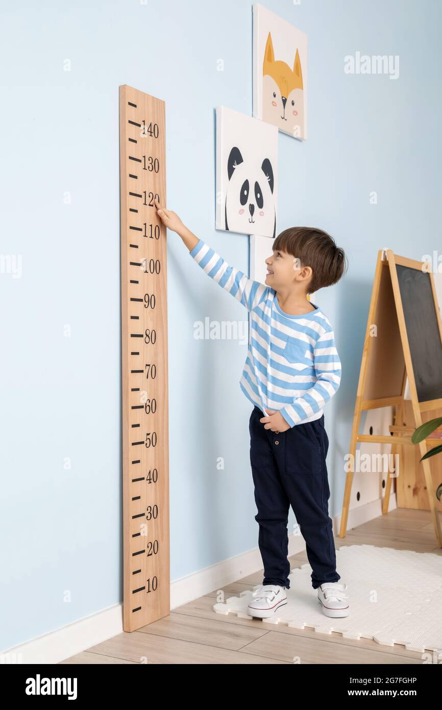 Little boy measuring height at home Stock Photo