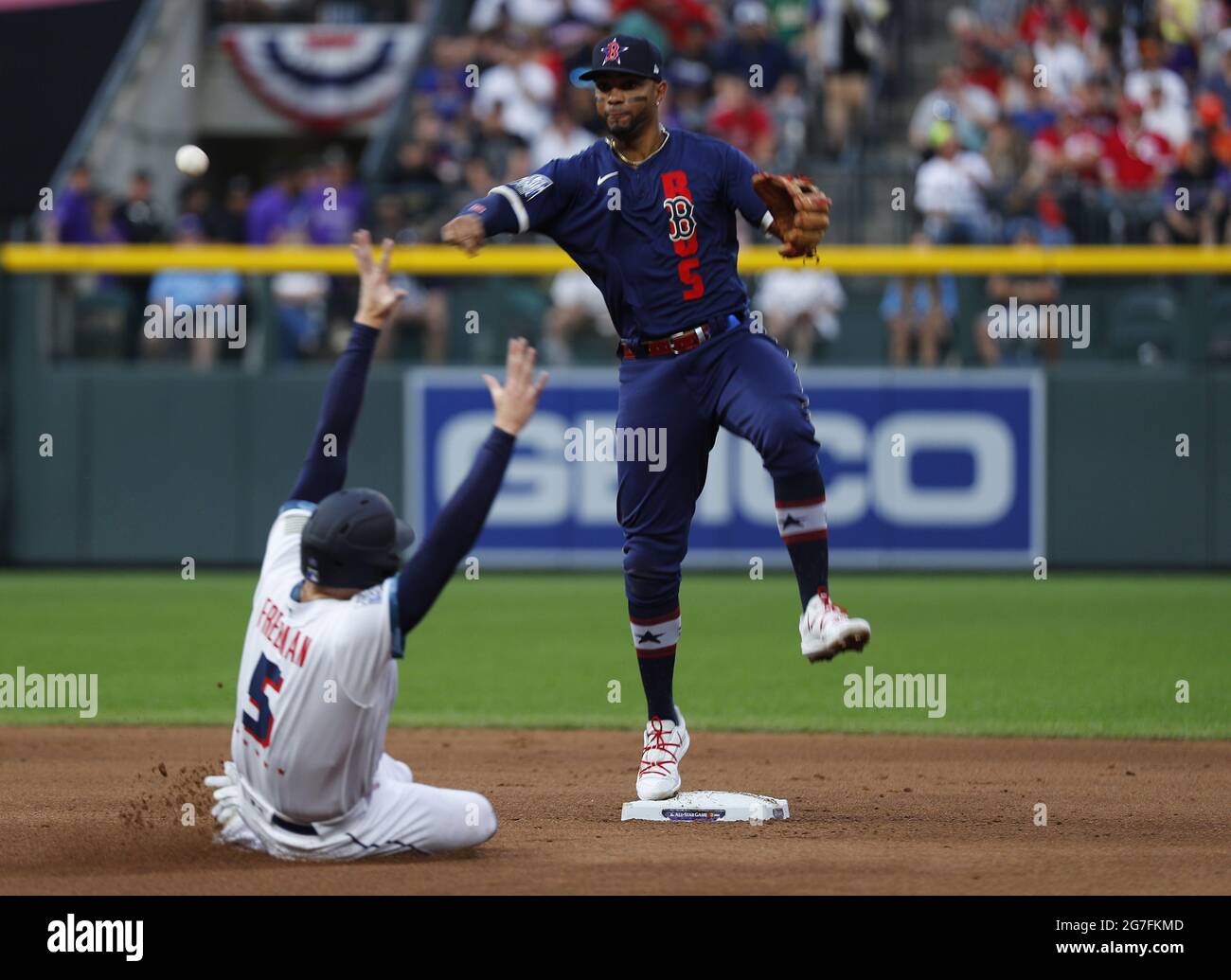 Denver, United States. 13th July, 2021. Boston Red Sox shortstop Xander Bogaerts leaps in the air to avoid a slide by Atlanta Braves first baseman Freddie Freeman in the fourth inning during the 2021 MLB All-Star Game at Coors Field in Denver, Colorado, on Tuesday, July 13, 2021. Photo by Bob Strong/UPI Credit: UPI/Alamy Live News Stock Photo