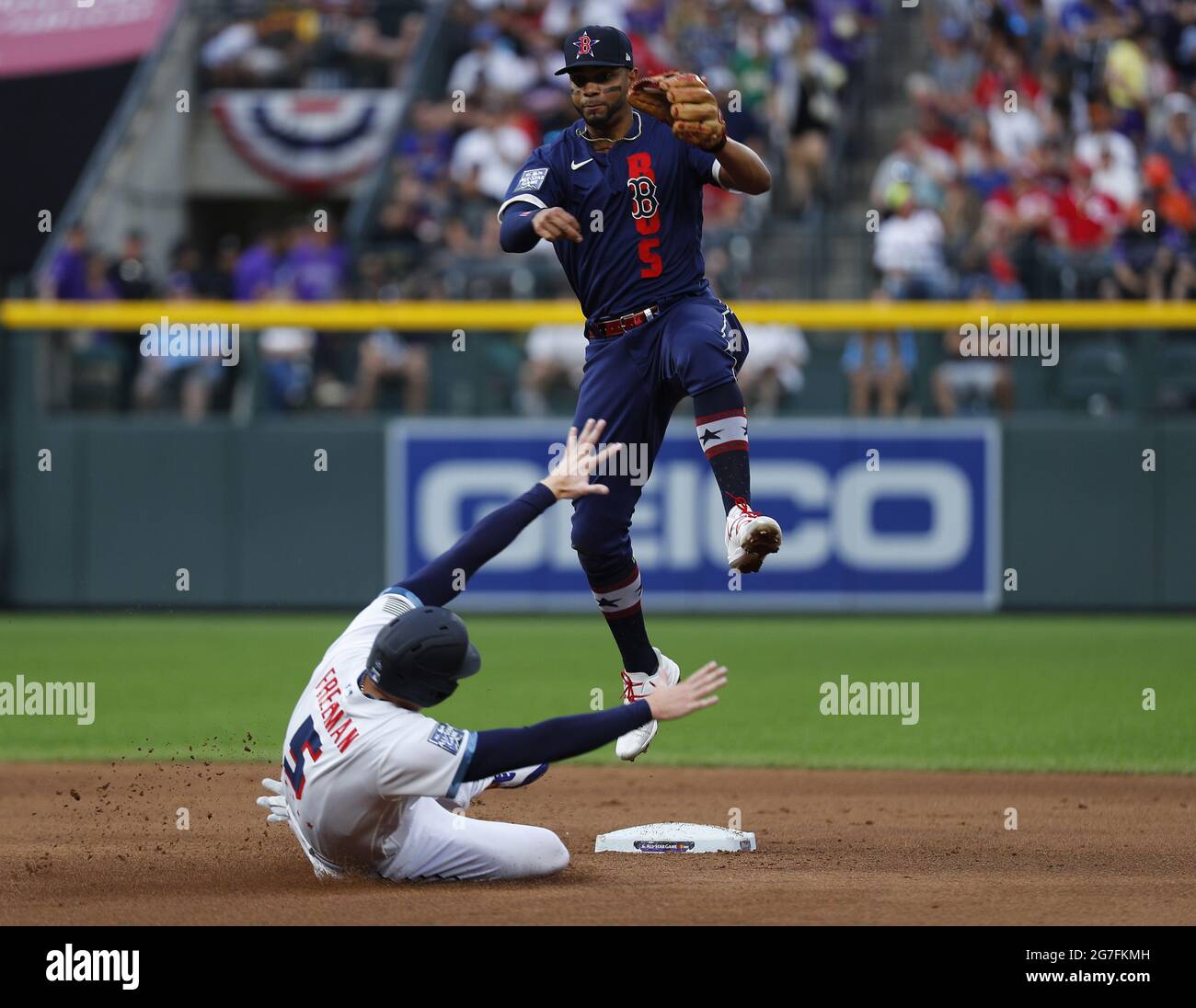 Denver, United States. 13th July, 2021. Boston Red Sox shortstop Xander Bogaerts leaps in the air to avoid a slide by Atlanta Braves first baseman Freddie Freeman in the fourth inning during the 2021 MLB All-Star Game at Coors Field in Denver, Colorado, on Tuesday, July 13, 2021. Photo by Bob Strong/UPI Credit: UPI/Alamy Live News Stock Photo