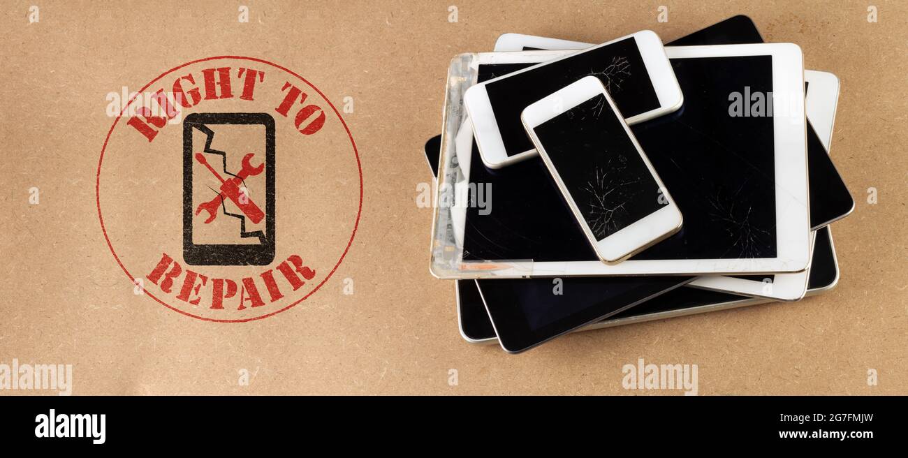 right to repair symbol next to broken tablets and smart phones on board consumer right to repair goods Stock Photo