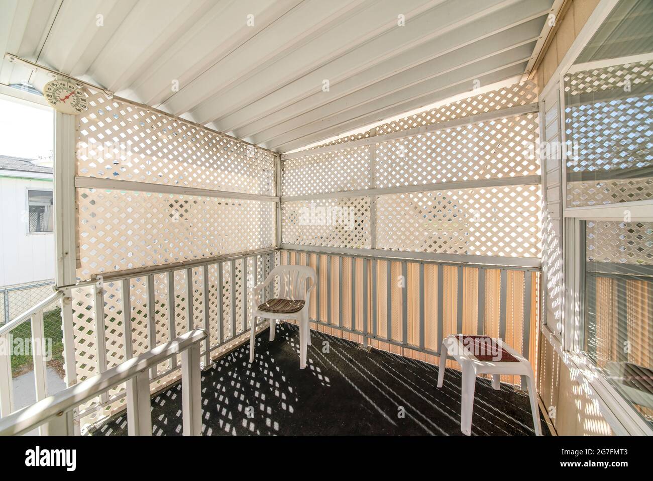 Entrance of a house with lattice privacy wall screen Stock Photo - Alamy