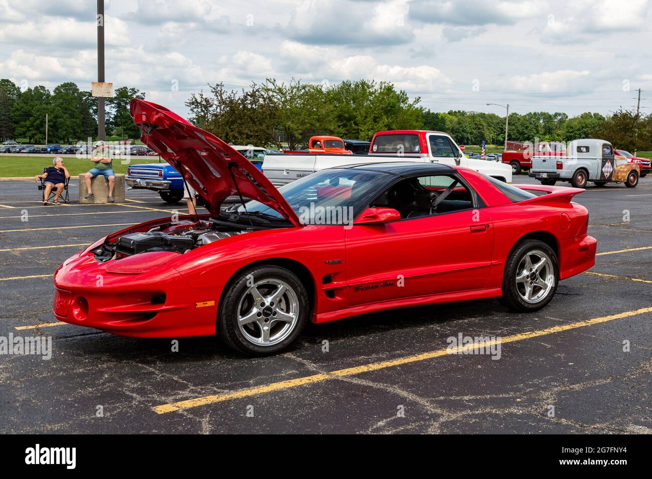 A red 2000 Pontiac Firebird Trans Am coupe on display with the hood open at a car show in Angola, Indiana, USA. Stock Photo