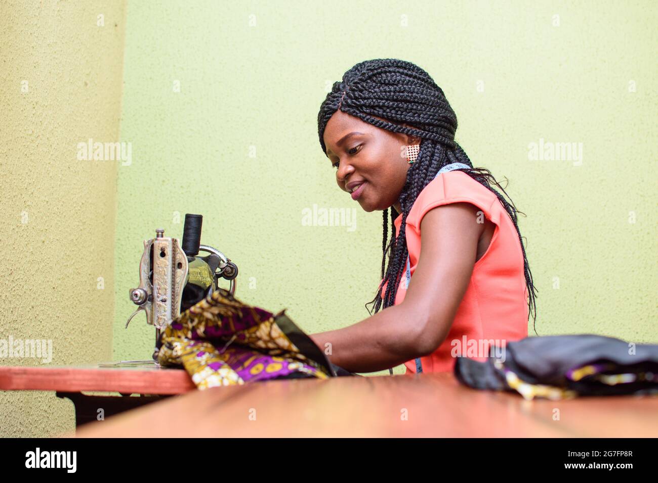 An industrious African female tailor fashion designer or dress maker making stylish and fashionable clothes with sewing machine in a tailoring works Stock Photo Alamy