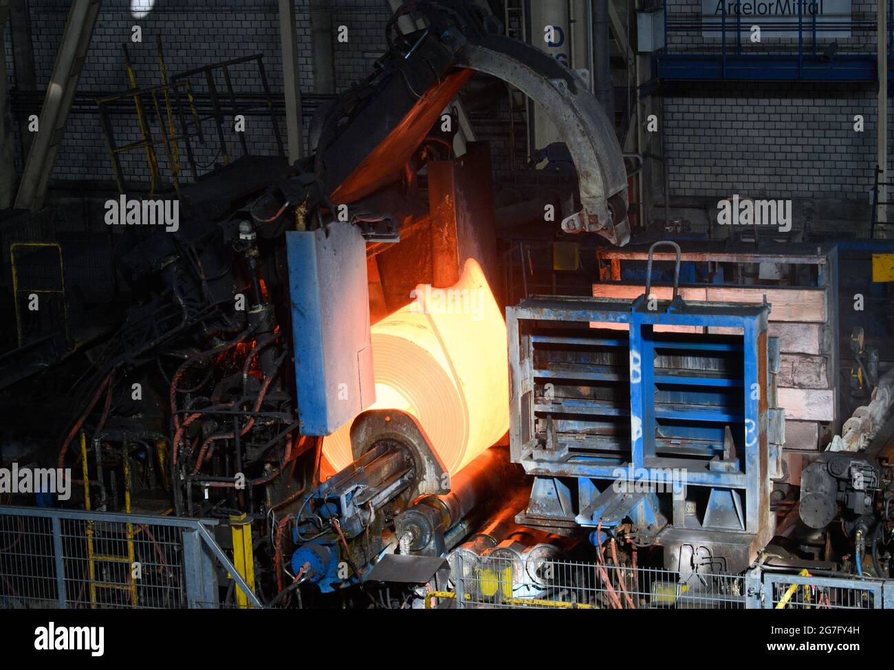 13 July 2021, Brandenburg, Eisenhüttenstadt A redhot slab is wound into a coil in