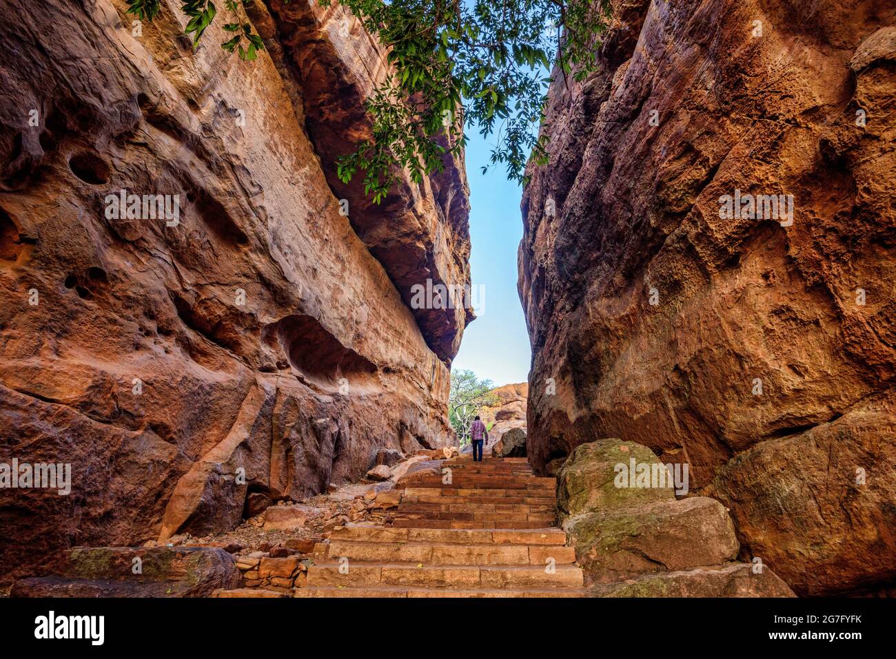 Path through steep cliffs, Entrance for lower and upper Shivalaya in Badami, Karnataka, INDIA. Passageway through rock cliffs. Stock Photo