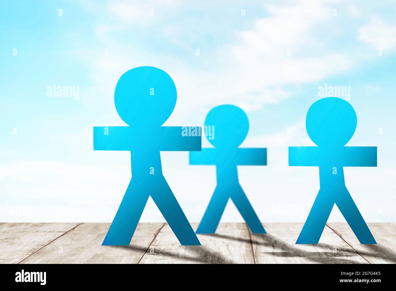 Blue people paper standing with a blue sky background. World Population Day concept Stock Photo