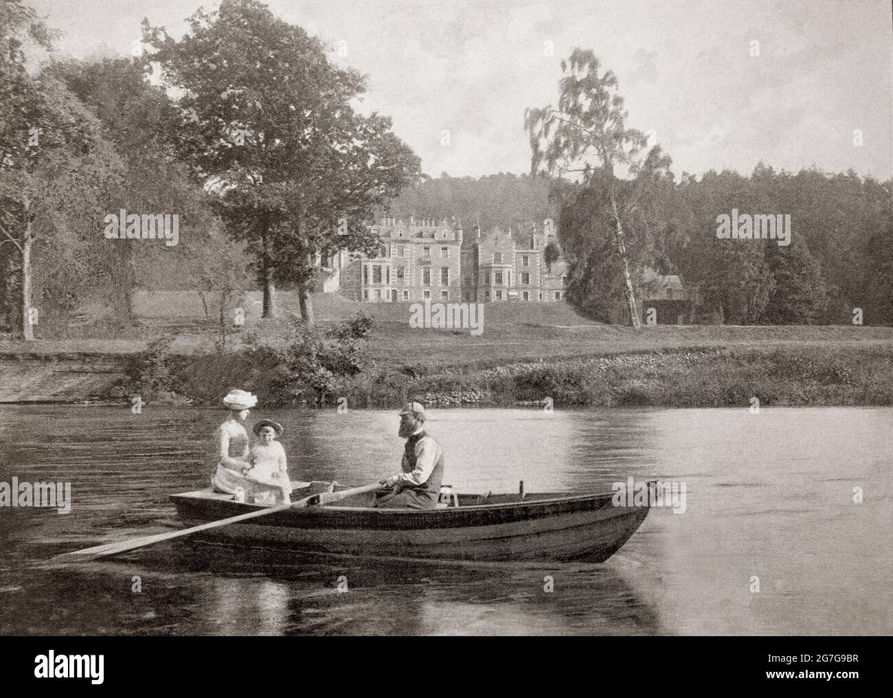 A late 19th century view of a family rowing on the River Tweed passed Abbotsford, a country house, formerly the residence of historical novelist and poet Sir Walter Scott in the Scottish Borders, near Galashiels. Expanded between 1816–19 and 1822–24, Scott gathered a large library, a collection of ancient furniture, arms and armour, and other relics and curiosities especially connected with Scottish history, notably the Celtic Torrs Pony-cap and Horns and the Woodwrae Stone, all now in the Museum of Scotland. Stock Photo