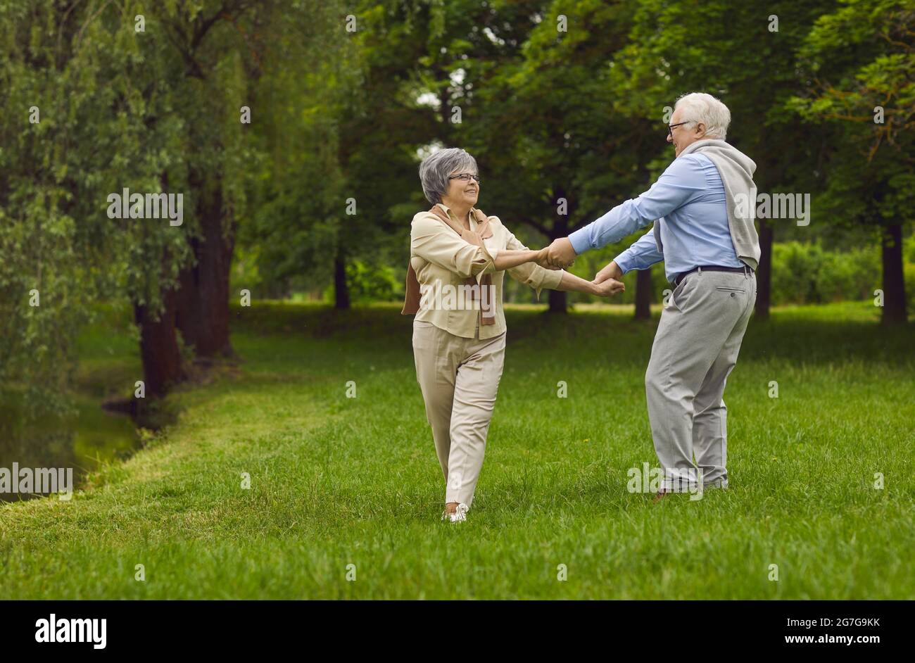 Happy elderly pensioners, man and woman, husband and wife, dancing together Stock Photo