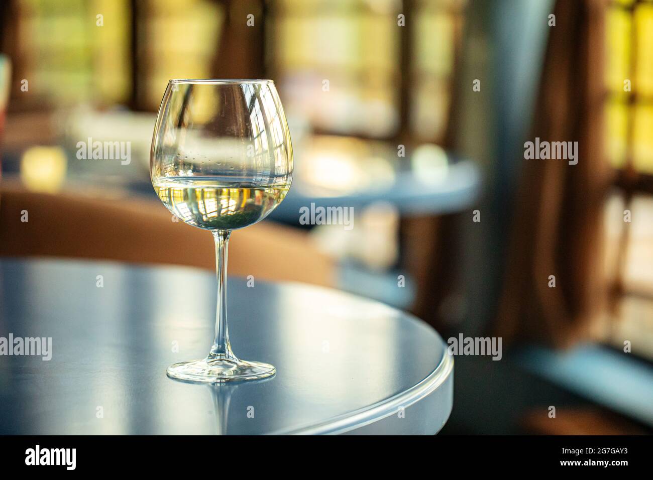 Glass of white wine on the restaurant table Stock Photo