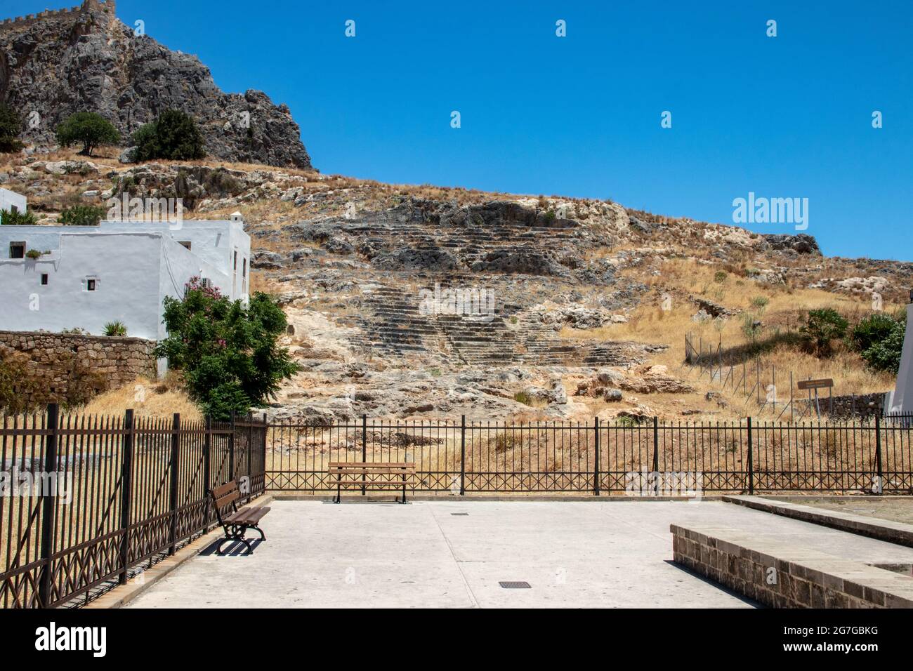 LINDOS, Greece - JUN 05, 2021. A theatre carved out of rock has been uncovered on the southern slope of the Acropolis. It is dated to the 4th century Stock Photo