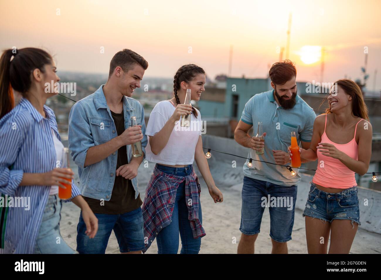 Fun Rooftop Party Group of happy friends having fun at rooftop party Stock Photo - Alamy