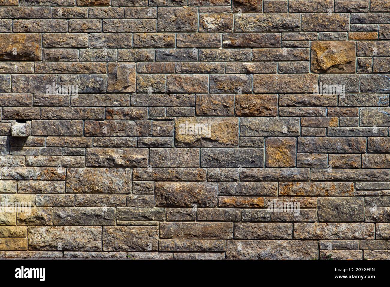 Natural brown and beige stone brick wall background texture Stock Photo