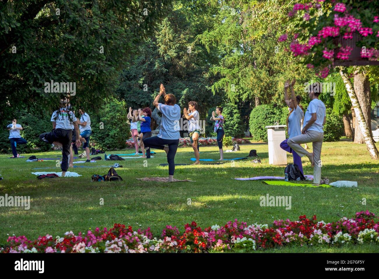 Zrenjanin, Serbia, June 19, 2021. Celebrating World Yoga Day in the city hall park. Yoga is practiced and meditated in nature. This location has tradi Stock Photo