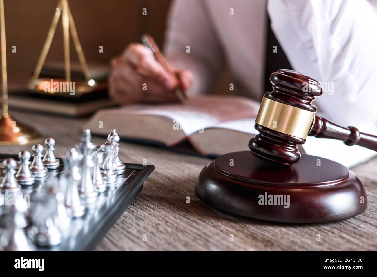 Judge gavel with scales of justice, male lawyers working having at law firm in office. Concepts of law advice and justice. Stock Photo