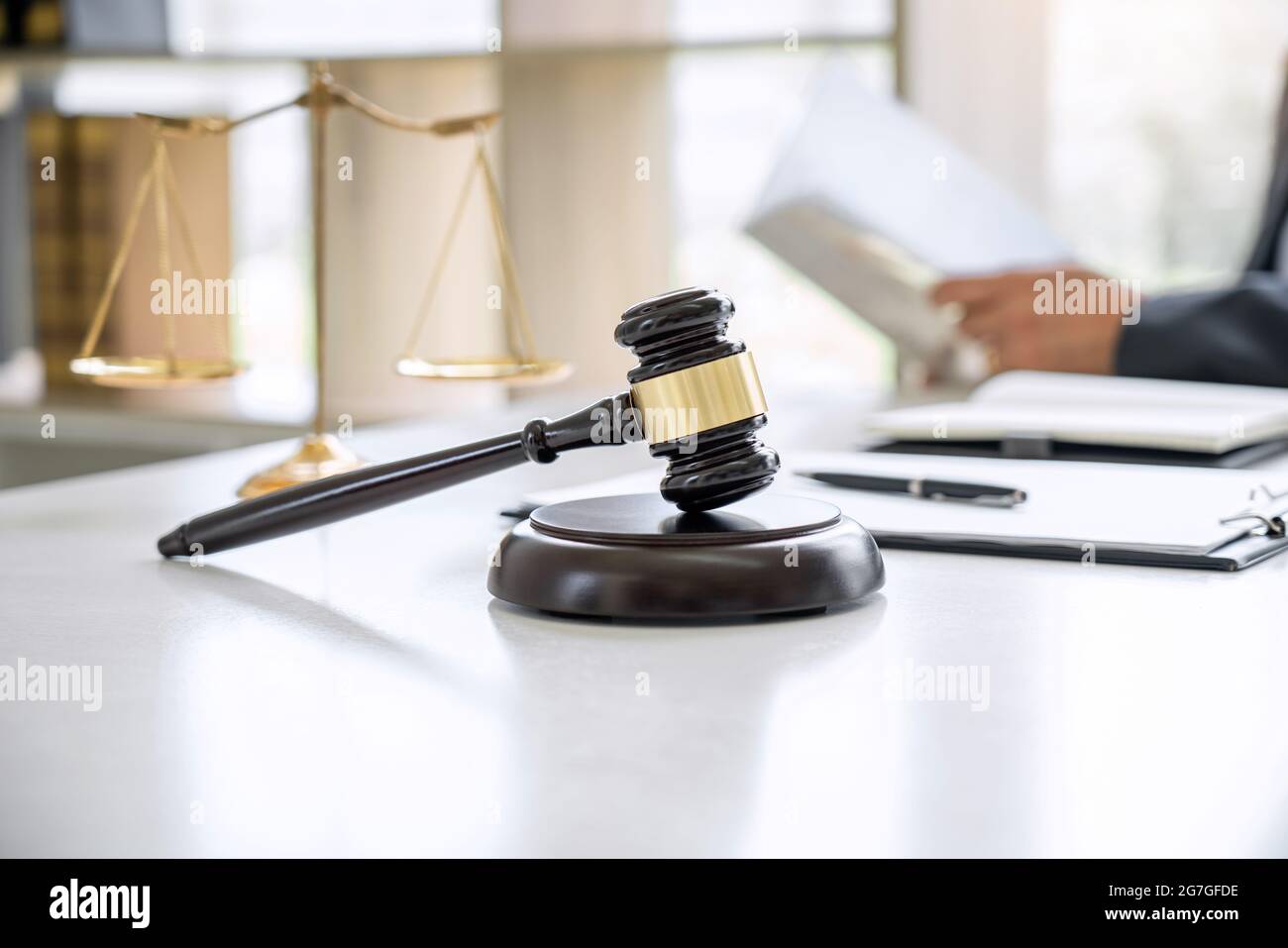 Judge gavel with Justice lawyers, Counselor in suit or lawyer working on a documents in courtroom, Legal law, advice and justice concept. Stock Photo