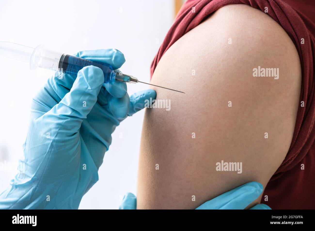 Doctor making injection vaccination patient to prevent pandemic of the disease, flu or influenza virus in clinic. Stock Photo