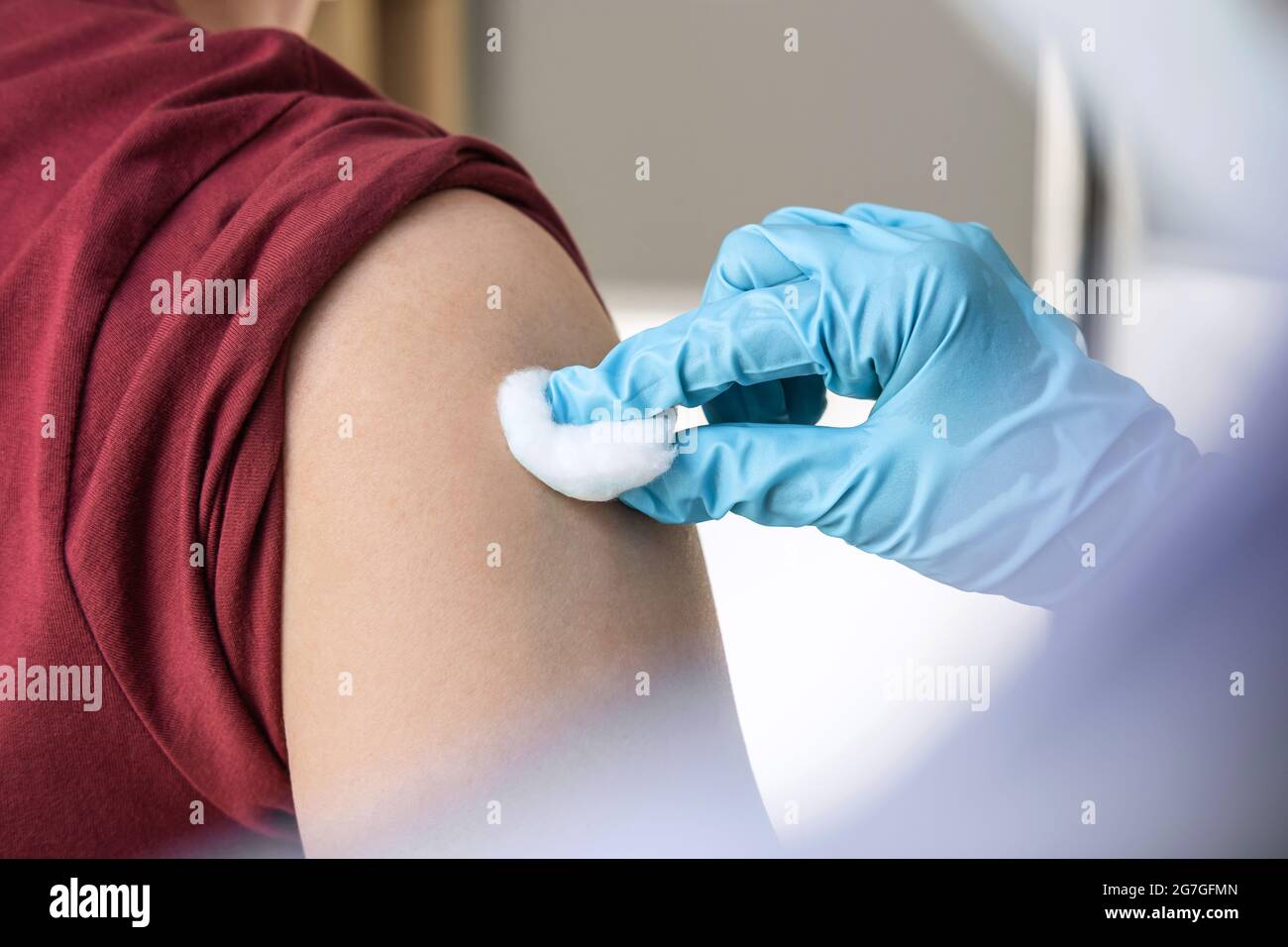 Doctor making injection vaccination patient to prevent pandemic of the disease, flu or influenza virus in clinic. Stock Photo