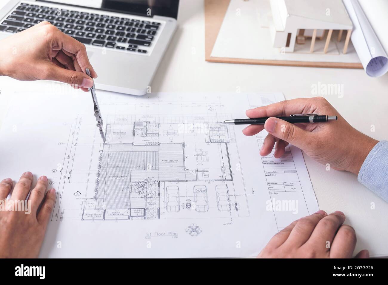 Engineering or Creative architect in construction project, Engineers hands working with compasses on construction blueprint building at a workplace in Stock Photo