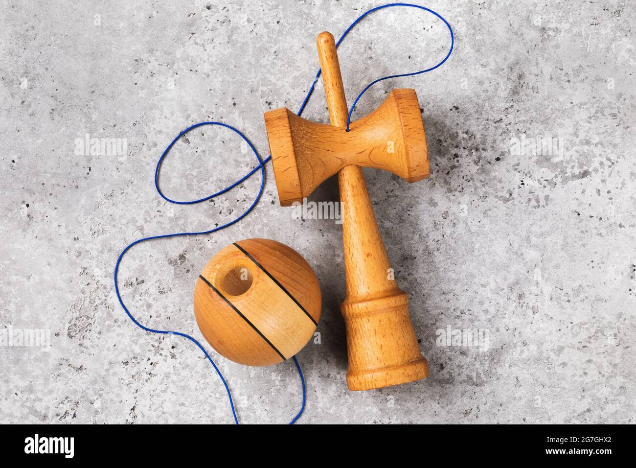 Kendama Japanese wooden toy with blue thread on a concrete background, top view Stock Photo Alamy