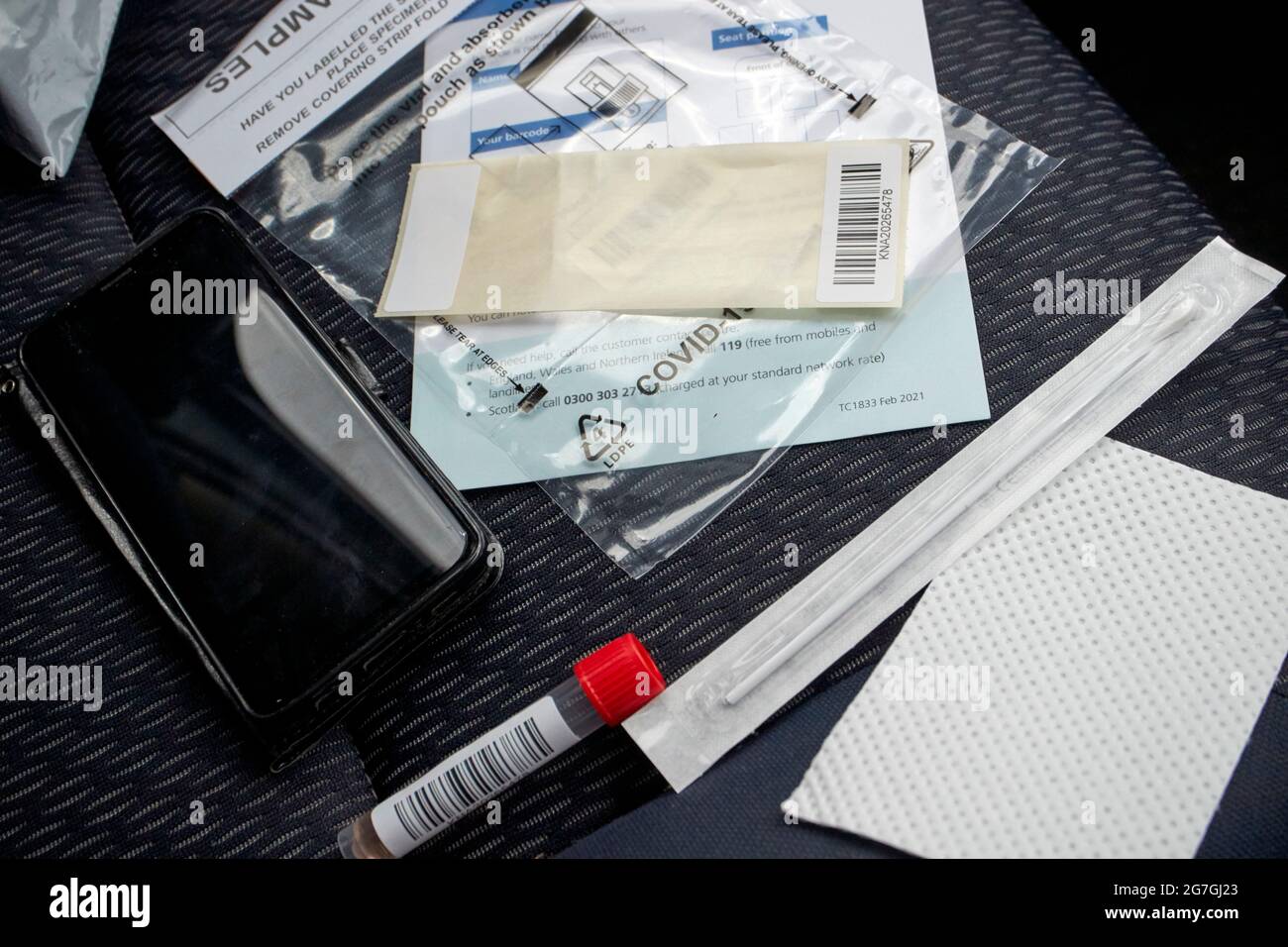 Covid-19 pcr test kit on the passenger seat of a car at a drive through test centre Stock Photo
