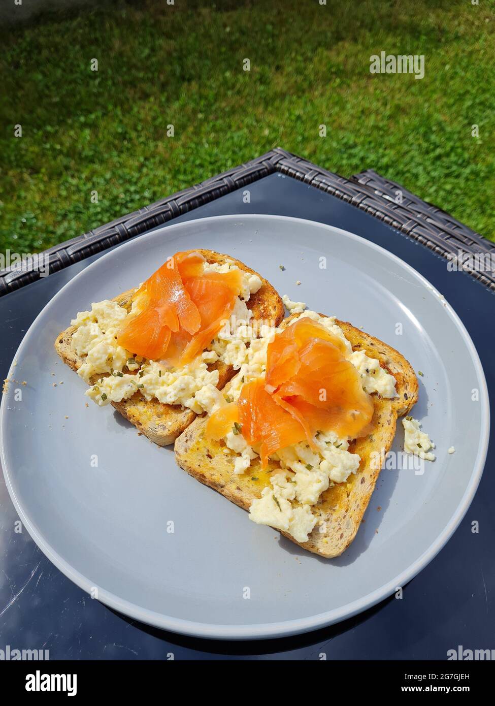 smoked salmon with scrambled egg on grain bread in the uk Stock Photo