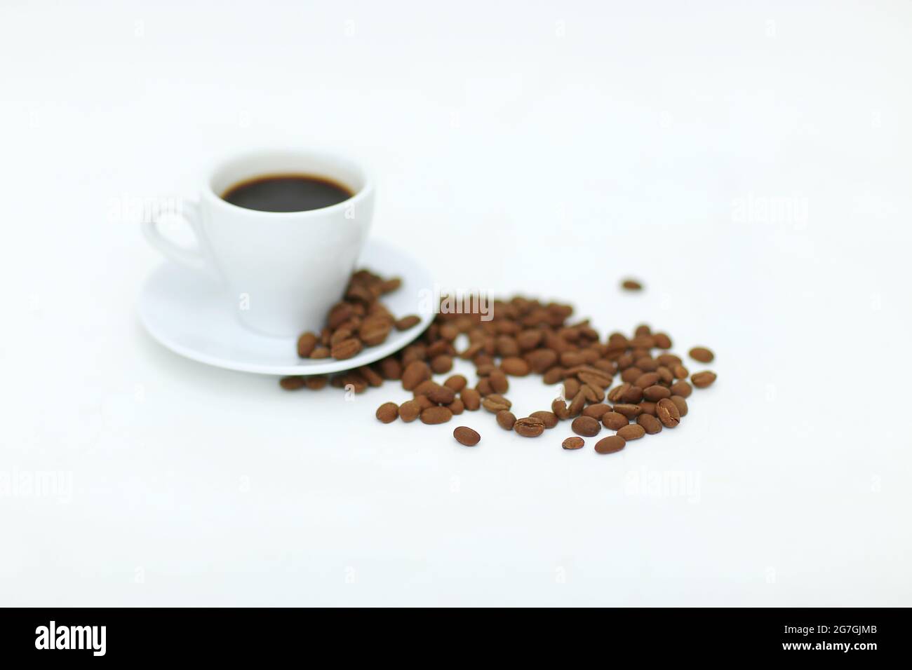 Coffee cup and beans isolated on a white background Stock Photo - Alamy