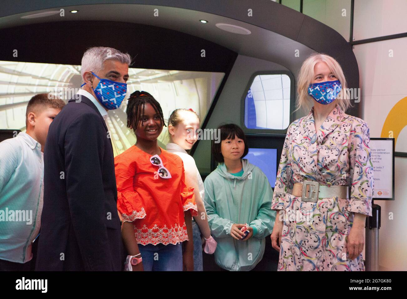 London, UK, 14 July 2021: London Mayor Sadiq Khan visited Covent Garden and the London Transport Museum this morning to launch his #LetsDoLondon campaign. The aim is to encourage tourists to visit central London. As he and Transport for London are making masks compulsory on London Underground it is hoped that tourists can visit safely despite rising coronavirus numbers. At the museum he got to sit in the driver's seat of a bus, which honours his father's job as a bus driver. With him were Justine Simons (Deputy Mayor for Culture and the Creative Industries) and Sam Mullins (Director of the Lon Stock Photo