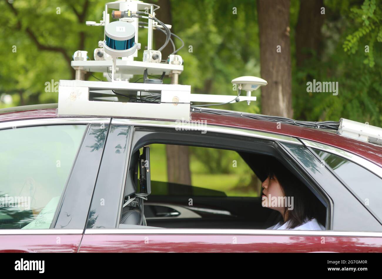 Shenyang, China's Liaoning Province. 9th July, 2021. An engineer from Neusoft Reach Automobile Technology Co., Ltd. tests a self-driving vehicle in Shenyang, northeast China's Liaoning Province, July 9, 2021. The company has recently tested its level-4 self-driving vehicles on both closed and open roads. Credit: Yang Qing/Xinhua/Alamy Live News Stock Photo