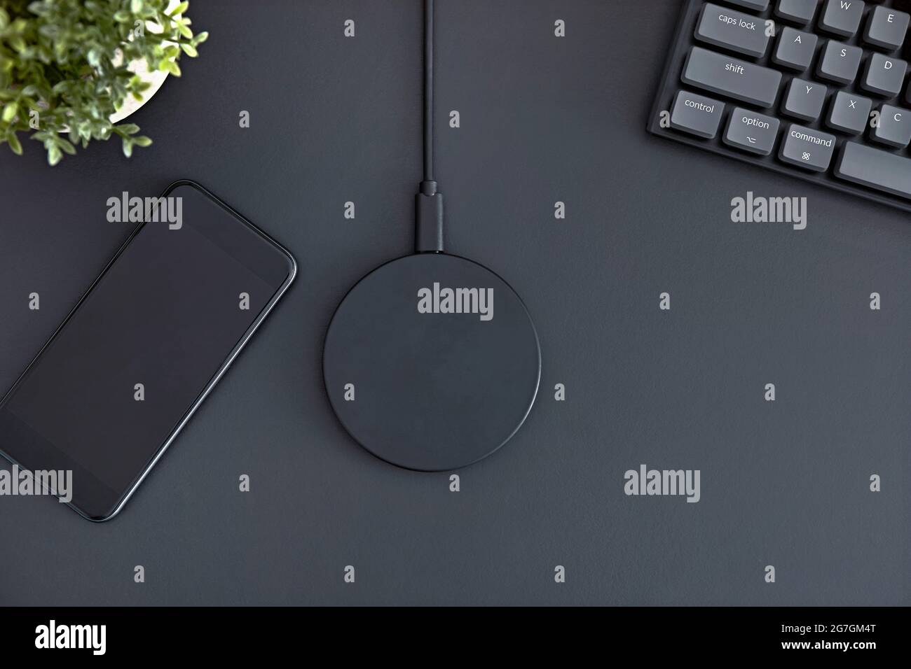 Flatlay of office desk. Smartphone, wireless charger and computer ...