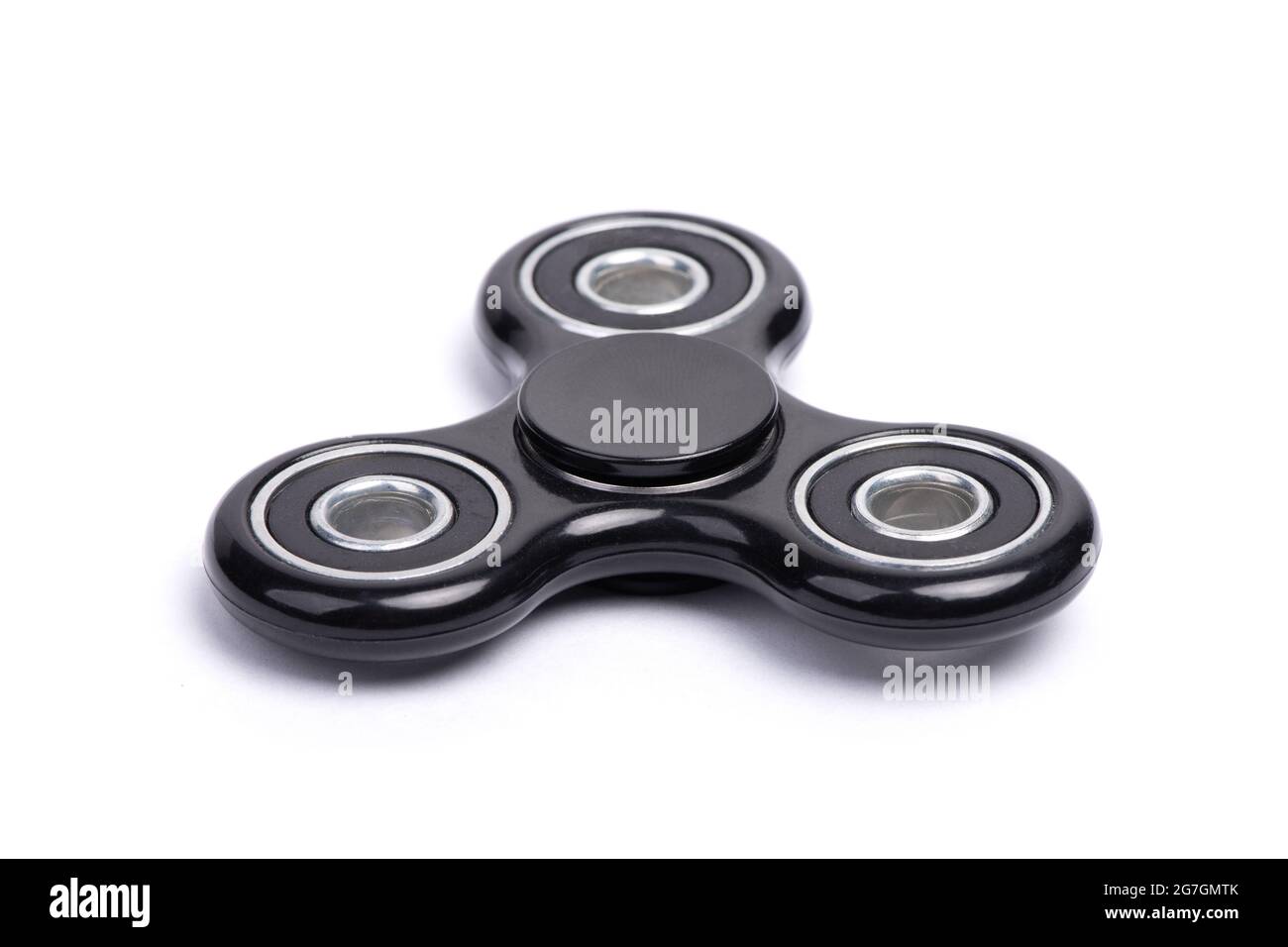 Close-up of black fidget spinner isolated over white background Stock Photo