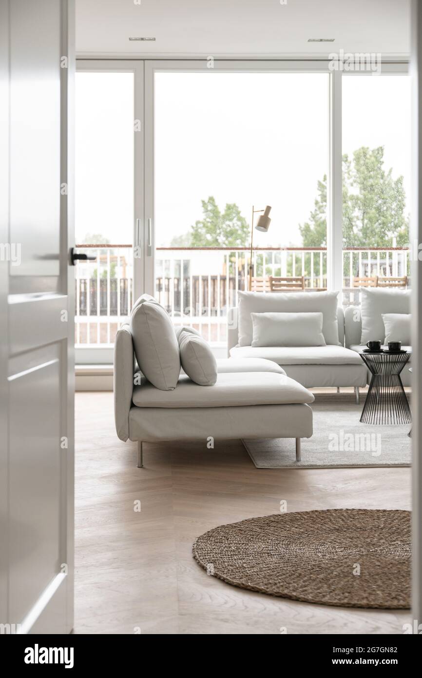 View from the door to a living room with stylish sofa Stock Photo - Alamy