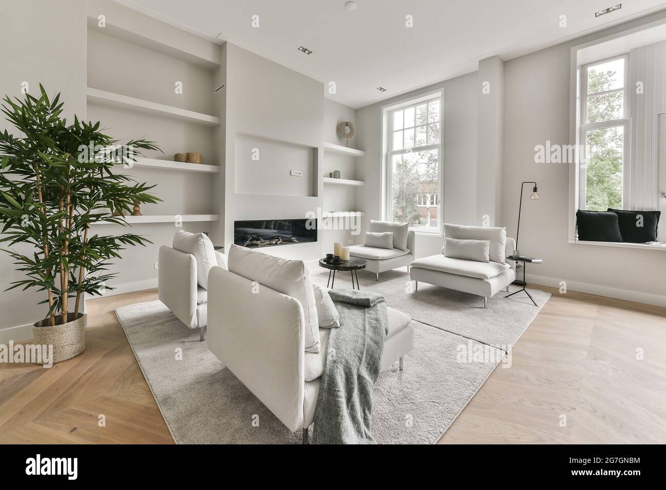 Cozy living room with a fireplace in apartment Stock Photo - Alamy