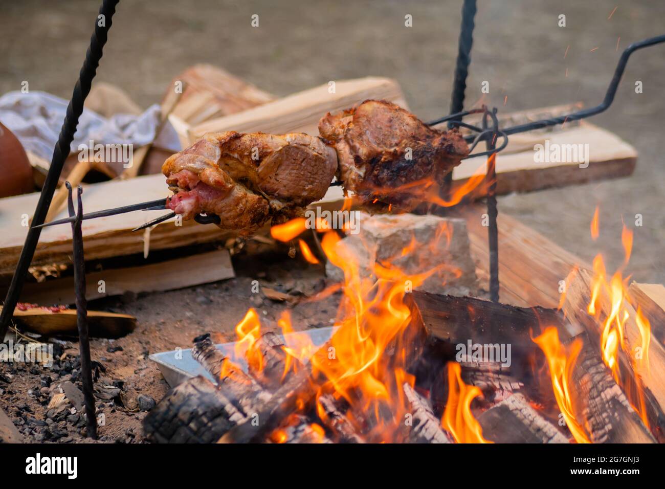 Process of cooking large meat peaces on spit over open fire Stock Photo Alamy