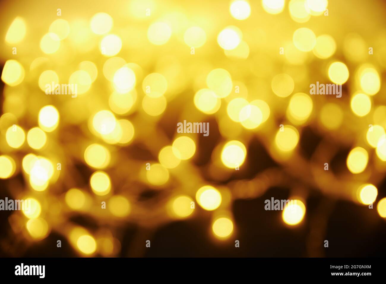 Golden colored blurred background. Abstract background with bokeh. Stock Photo