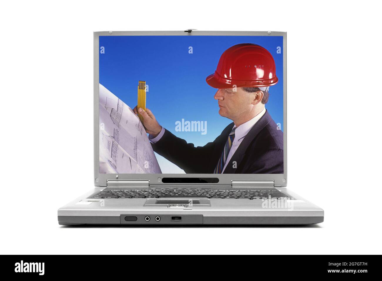 architect with construction helmet on the display of a laptop computer Stock Photo