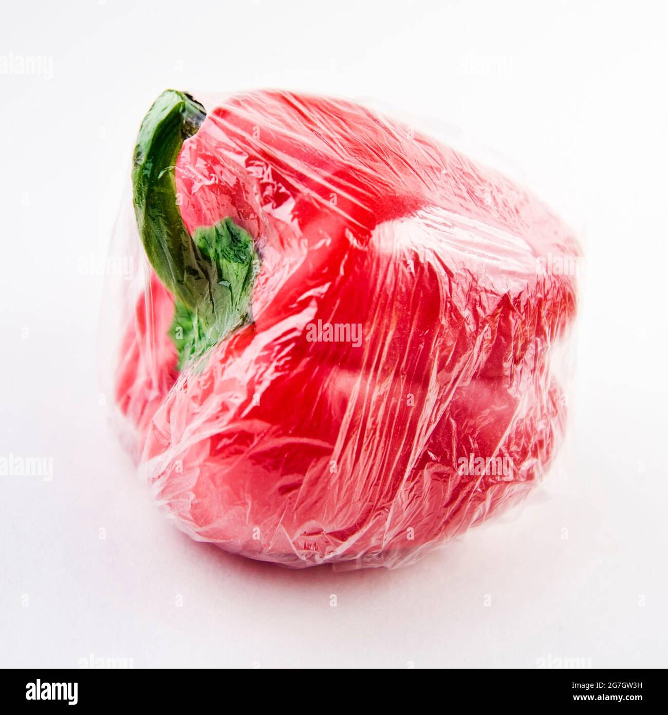 chili pepper, paprika (Capsicum annuum), red pepper in cling film Stock Photo