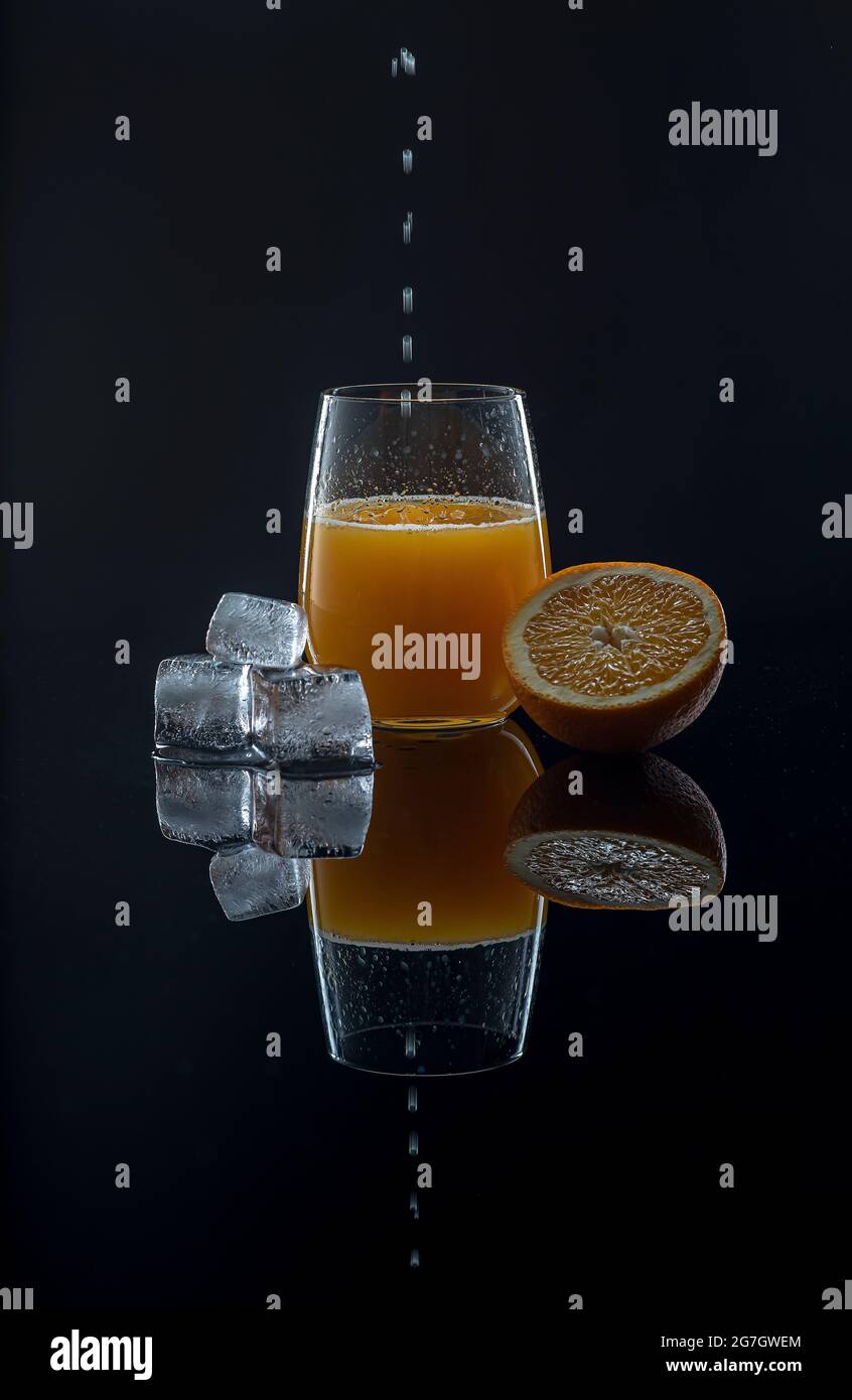 Food photography of orange juice, ice cubes, orange Stock Photo Alamy