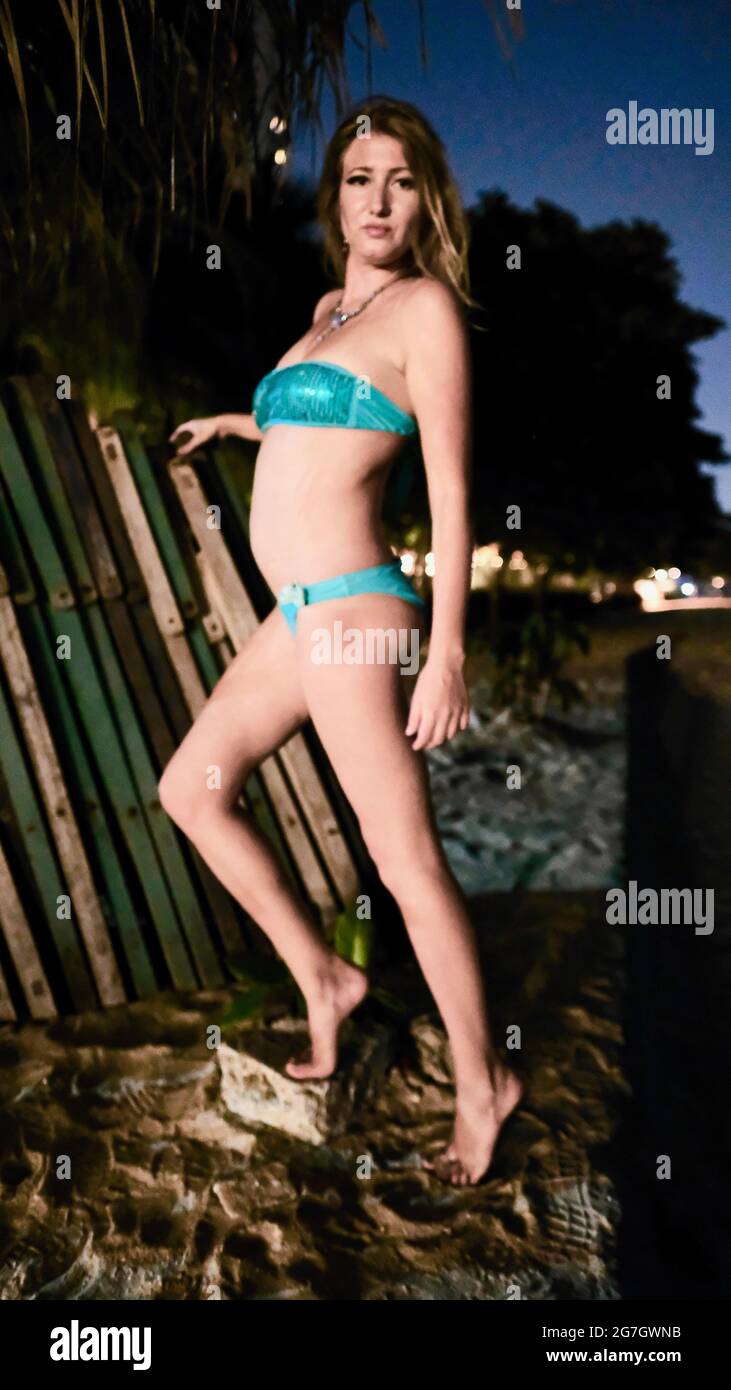 Eastern European Caucasian woman middle aged blonde hair light skin pale  complexion in Blue Bikini at night posing on the sand wearing a neckless  Stock Photo - Alamy