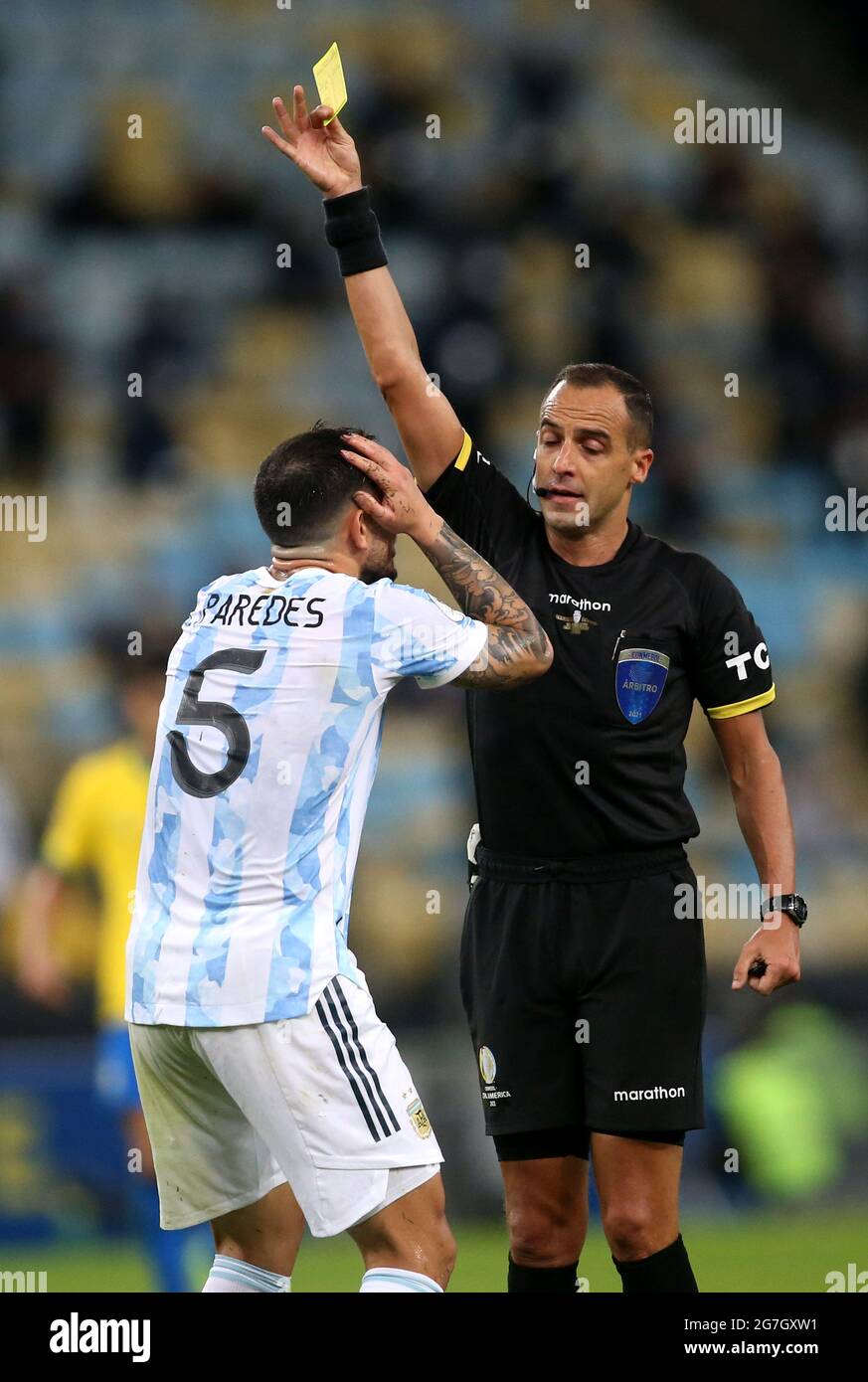 RIO DE JANEIRO, BRAZIL - JULY 10: Leandro Paredes of Argentina is sanctioned by the referee Esteban Ostojich with a yellow card for the foul ,during the Final Match of Copa America Brazil 2021 between Brazil and Argentina at Maracana Stadium on July 10, 2021 in Rio de Janeiro, Brazil. (MB Media) Stock Photo