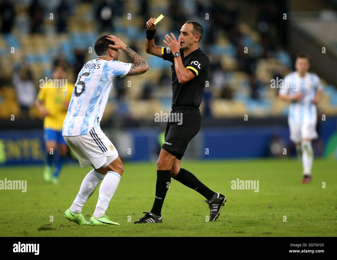 RIO DE JANEIRO, BRAZIL - JULY 10: Leandro Paredes of Argentina is sanctioned by the referee Esteban Ostojich with a yellow card for the foul ,during the Final Match of Copa America Brazil 2021 between Brazil and Argentina at Maracana Stadium on July 10, 2021 in Rio de Janeiro, Brazil. (MB Media) Stock Photo