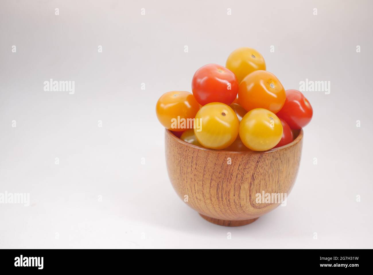 red and yellow color cherry tomato in a bowl on white background Stock ...