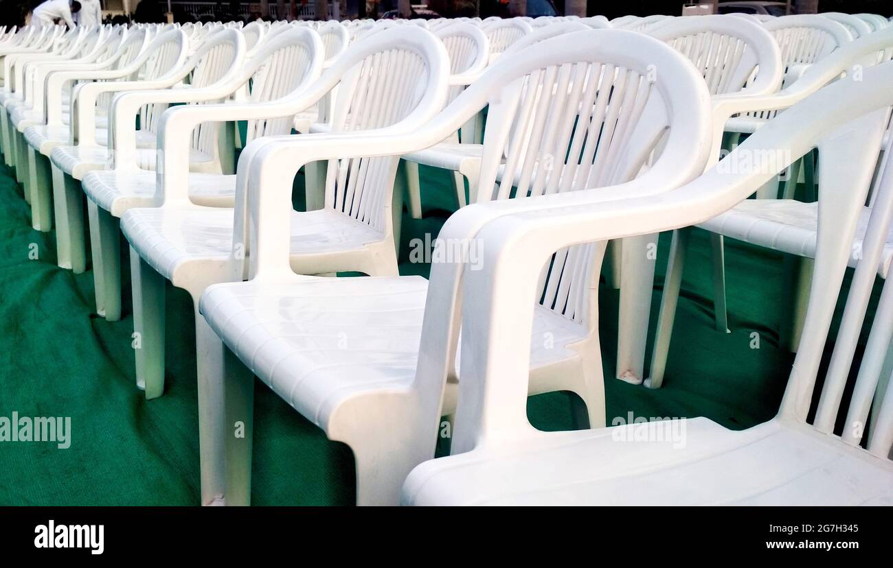 Rows of empty white chairs waiting for the audience in india Stock Photo