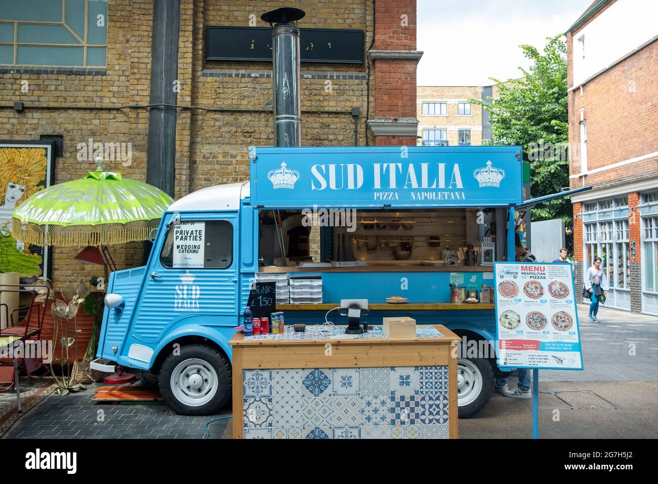 London- July, 2021: A pizza truck inside Spitalfields market in East London Stock Photo