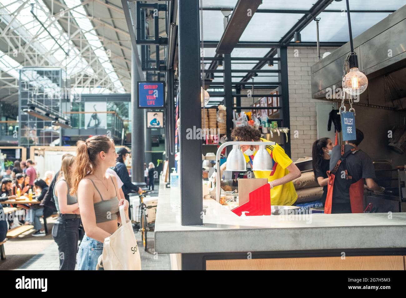 London- July, 2021: Food stalls inside Spitalfields Market.  A popular market with food, bars, arts and crafts Stock Photo