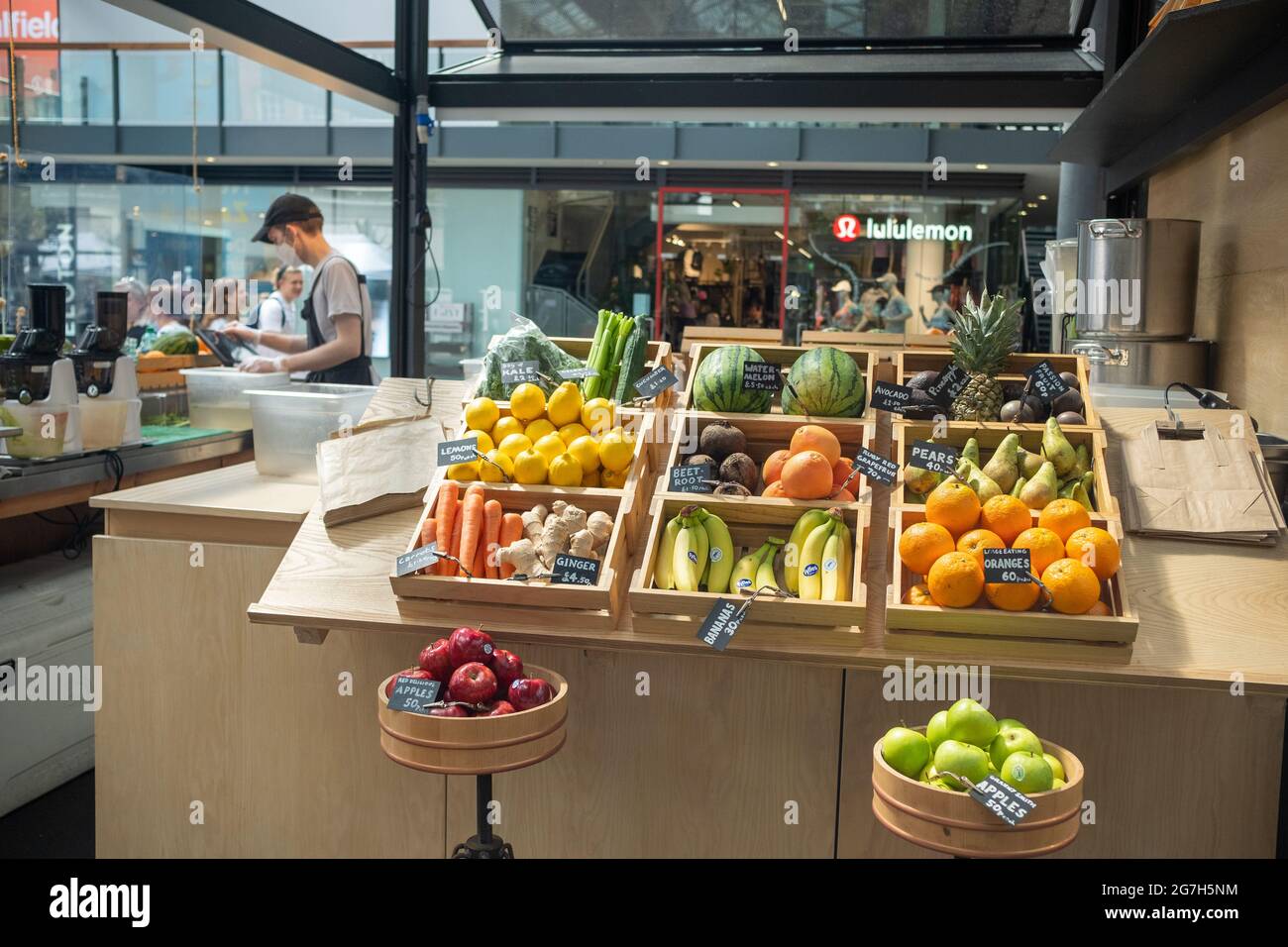 London- July, 2021:  Fresh fruit on display at smoothie stall inside Spitalfields indoor market in East London. Stock Photo