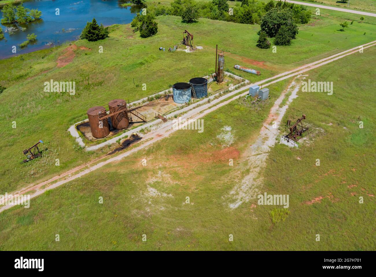 Oil pump on wide open prairie in Oklahoma USA an oil well pump jack pumping Stock Photo