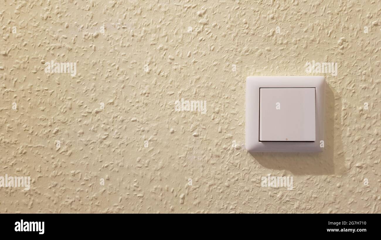 Light switch on the wall on yellow background Stock Photo Alamy