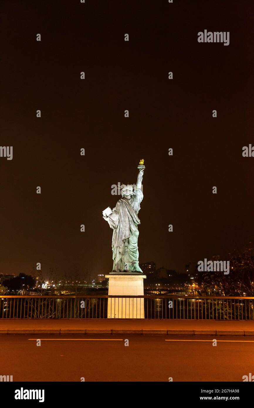 Statue of Liberty at the Pont de Grenelle at night. Paris Stock Photo