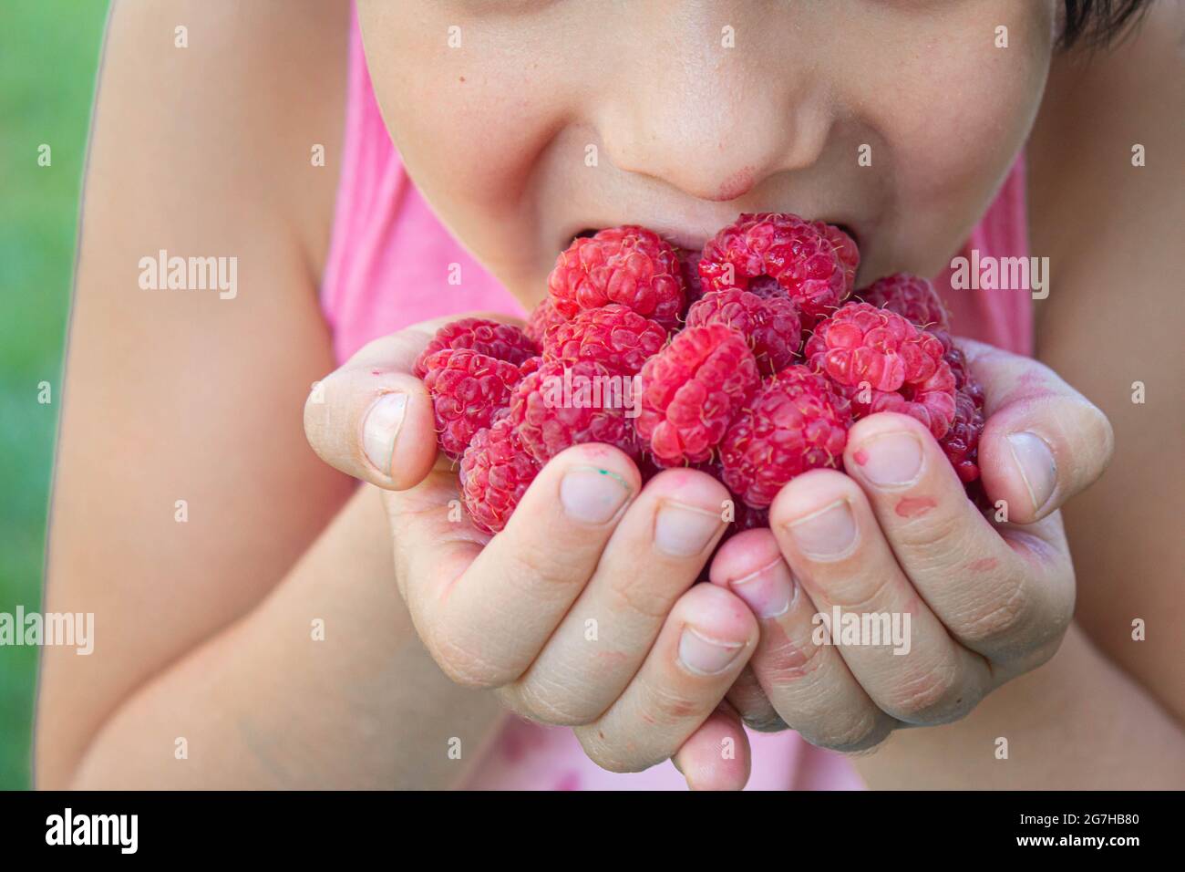 baby eats raspberries .selective focusfood Stock Photo - Alamy