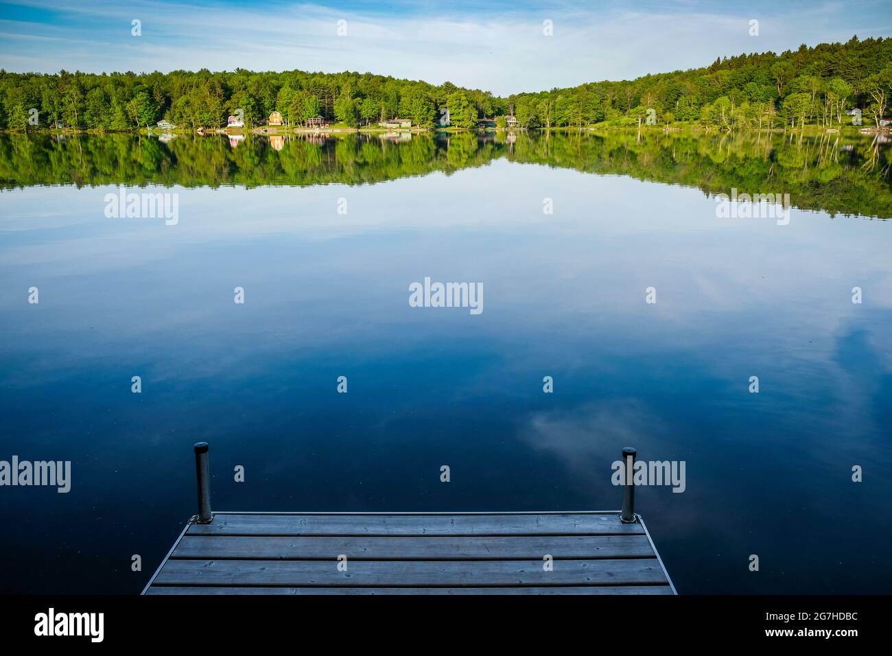 Beautifully placid lake seen from dock on a lake near Copperstown, NY, USA. Stock Photo